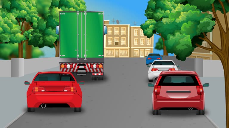 Pedestrians crossing between the vehicles.