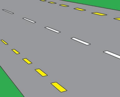 The edge of the carriageway or hard shoulder.